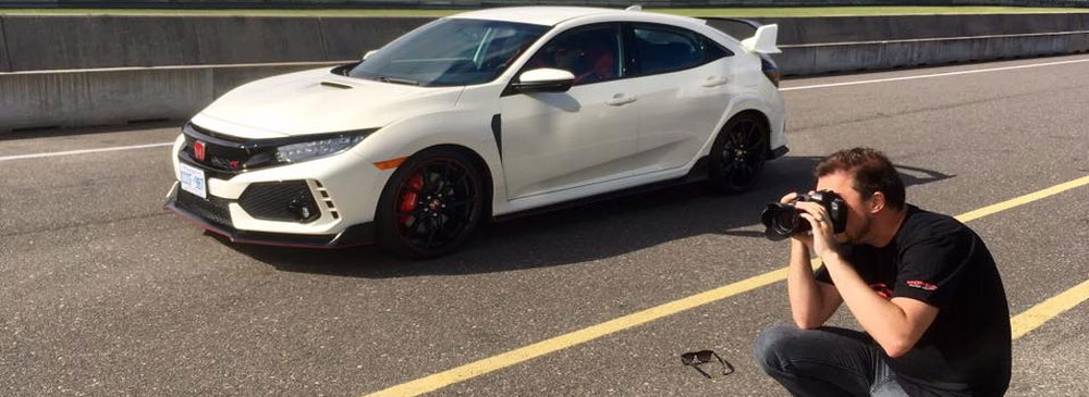 Close up of man filming Honda Type R on racetrack